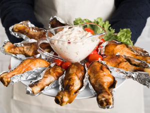 Chef holding plate with chicken